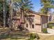 Charming multi-level home featuring a red door, beautiful wooden accents and a lush green lawn at 715 Wallington Way, Lawrenceville, GA 30046