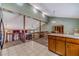 Open-concept dining and living area with wooden railing, skylights, and hardwood cabinets at 715 Wallington Way, Lawrenceville, GA 30046