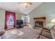 Bright living room featuring a stone fireplace, large window, high ceilings, and cozy seating at 715 Wallington Way, Lawrenceville, GA 30046