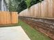 Fenced backyard with concrete patio and retaining wall at 1024 Rose Dr, Marietta, GA 30060