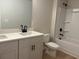 Modern bathroom with a double vanity, quartz countertops, and a shower-tub combo with black hardware at 1024 Rose Dr, Marietta, GA 30060
