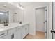 Bathroom featuring double vanity, modern fixtures, tile shower, and wood flooring at 1024 Rose Dr, Marietta, GA 30060