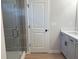 Bathroom with a glass enclosed shower and white vanity with black hardware at 1024 Rose Dr, Marietta, GA 30060