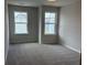 Well-lit bedroom with two windows, neutral walls, and soft carpeting, creating a cozy atmosphere at 1024 Rose Dr, Marietta, GA 30060