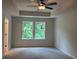 Bedroom with tray ceiling, ceiling fan, two windows offering natural light at 1024 Rose Dr, Marietta, GA 30060