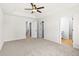 Bedroom boasts a ceiling fan, neutral carpet and access to an en-suite bathroom at 1024 Rose Dr, Marietta, GA 30060
