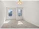 Well-lit bedroom with neutral carpet, two windows, and modern ceiling light at 1024 Rose Dr, Marietta, GA 30060