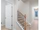 Bright entryway featuring a wooden staircase with black iron railings and views into the home at 1024 Rose Dr, Marietta, GA 30060