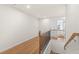 Upstairs hallway with wood floors, black iron railing and white walls at 1024 Rose Dr, Marietta, GA 30060