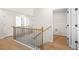 Hallway featuring wooden floors, staircase with black railings, and multiple doors at 1024 Rose Dr, Marietta, GA 30060