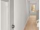 Light-filled hallway featuring neutral walls and light-colored carpet and view of stairs with iron railing at 1024 Rose Dr, Marietta, GA 30060