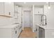 Bright kitchen with white cabinets, stainless steel appliances, and light wood flooring at 1024 Rose Dr, Marietta, GA 30060