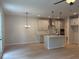 Open concept kitchen features an island, stainless appliances, hanging pendant lights, and seamless flow with living space at 1024 Rose Dr, Marietta, GA 30060