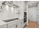Modern kitchen featuring white cabinets, stainless steel appliances, and a stylish backsplash at 1024 Rose Dr, Marietta, GA 30060