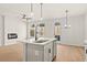 Bright open kitchen featuring a center island, stainless steel appliances and modern light fixtures at 1024 Rose Dr, Marietta, GA 30060