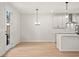 Eat-in kitchen featuring modern lighting, island with a sink, stainless appliances, and a door to the outside at 1024 Rose Dr, Marietta, GA 30060