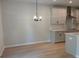 Bright dining area open to kitchen with modern light fixture and kitchen island at 1024 Rose Dr, Marietta, GA 30060