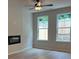 Bright living room with a fireplace, two large windows, and light wood flooring at 1024 Rose Dr, Marietta, GA 30060