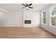 Open living room with fireplace and large windows offering plenty of natural light, and ceiling fan at 1024 Rose Dr, Marietta, GA 30060