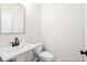 Elegant powder room with pedestal sink, dark faucet, and modern toilet at 1024 Rose Dr, Marietta, GA 30060