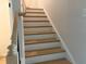 Close-up of staircase featuring light wood steps and white risers at 1024 Rose Dr, Marietta, GA 30060