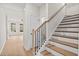 Elegant staircase featuring wooden steps, black iron railings, and abundant natural light, leading to the upper floor at 1024 Rose Dr, Marietta, GA 30060