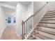 Elegant staircase with wooden steps and black iron railings, connecting to a spacious living area at 1024 Rose Dr, Marietta, GA 30060