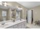 A bright bathroom featuring double sinks, a separate glass shower, and a jacuzzi tub at 1256 Melrose Forrest Ln, Lawrenceville, GA 30045