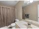 Standard bathroom with shower-tub combo, white toilet, and a single sink vanity at 1256 Melrose Forrest Ln, Lawrenceville, GA 30045