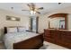 Bright bedroom with a wooden dresser, a bed, and a window for natural light at 1256 Melrose Forrest Ln, Lawrenceville, GA 30045