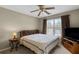 Cozy bedroom featuring a ceiling fan, neutral paint, and a window for natural light at 1256 Melrose Forrest Ln, Lawrenceville, GA 30045