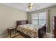 Bedroom featuring carpet, a ceiling fan, a window, and a bed with floral pattern linens at 1256 Melrose Forrest Ln, Lawrenceville, GA 30045