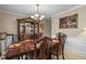 Formal dining room features elegant furnishings and a chandelier at 1256 Melrose Forrest Ln, Lawrenceville, GA 30045