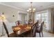 Dining room with a large table, chairs, chandelier, and natural light at 1256 Melrose Forrest Ln, Lawrenceville, GA 30045