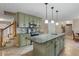 Spacious kitchen features light green cabinets and a large granite-topped island at 1256 Melrose Forrest Ln, Lawrenceville, GA 30045