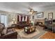 Cozy living room with a brick fireplace, plush leather sofas, and wood flooring at 1256 Melrose Forrest Ln, Lawrenceville, GA 30045