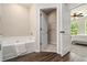 Bathroom with a separate closet, large soaking tub, vinyl floors and natural light at 1508 Burberry Aly, Marietta, GA 30008