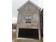 Two-story townhouse with stone facade and attached garage at 1508 Burberry Aly, Marietta, GA 30008