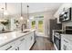 Bright modern kitchen with white cabinets and backyard view at 1508 Burberry Aly, Marietta, GA 30008