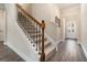 Elegant staircase with wood and iron railing and hardwood floors at 1508 Burberry Aly, Marietta, GA 30008