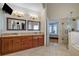 Bathroom featuring double vanity, mirrors, walk-in shower, and open doorway to bedroom at 2986 Nestle Creek Dr, Marietta, GA 30062