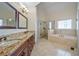 This bathroom features a soaking tub, glass enclosed shower, double vanity with granite countertops and tile flooring at 2986 Nestle Creek Dr, Marietta, GA 30062