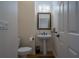 Powder room with pedestal sink, toilet, and ornate mirror at 2986 Nestle Creek Dr, Marietta, GA 30062