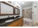 This bathroom has a double vanity with granite countertops, tile flooring and a shower-tub combination at 2986 Nestle Creek Dr, Marietta, GA 30062