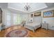 Bright bedroom with chandelier, tray ceiling, wood floors, and seating area at 2986 Nestle Creek Dr, Marietta, GA 30062