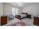 Bright bedroom featuring a sleigh bed, wooden furniture, neutral walls, and a vibrant area rug at 2986 Nestle Creek Dr, Marietta, GA 30062