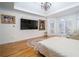 Bright bedroom featuring hardwood floors, bay window, television, and chandelier at 2986 Nestle Creek Dr, Marietta, GA 30062