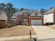 A well-maintained two-story home with a brick facade, a two-car garage, and a neatly kept front yard at 2986 Nestle Creek Dr, Marietta, GA 30062