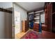 This walk-in closet features custom wood shelves and drawers, hanging rods, hardwood floors and a decorative rug at 2986 Nestle Creek Dr, Marietta, GA 30062