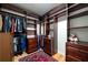 This walk-in closet features custom wood shelves and drawers, hanging rods, hardwood floors and a decorative rug at 2986 Nestle Creek Dr, Marietta, GA 30062